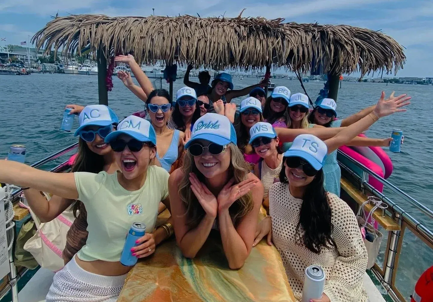 A large group in matching caps around the tiki bar mid-cruise