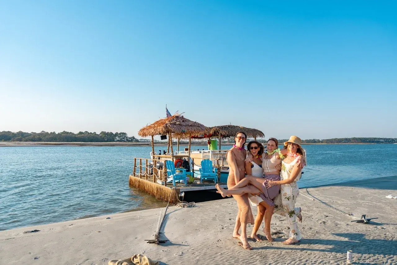 The tiki boat pulled up to a sandbar island with guests exploring