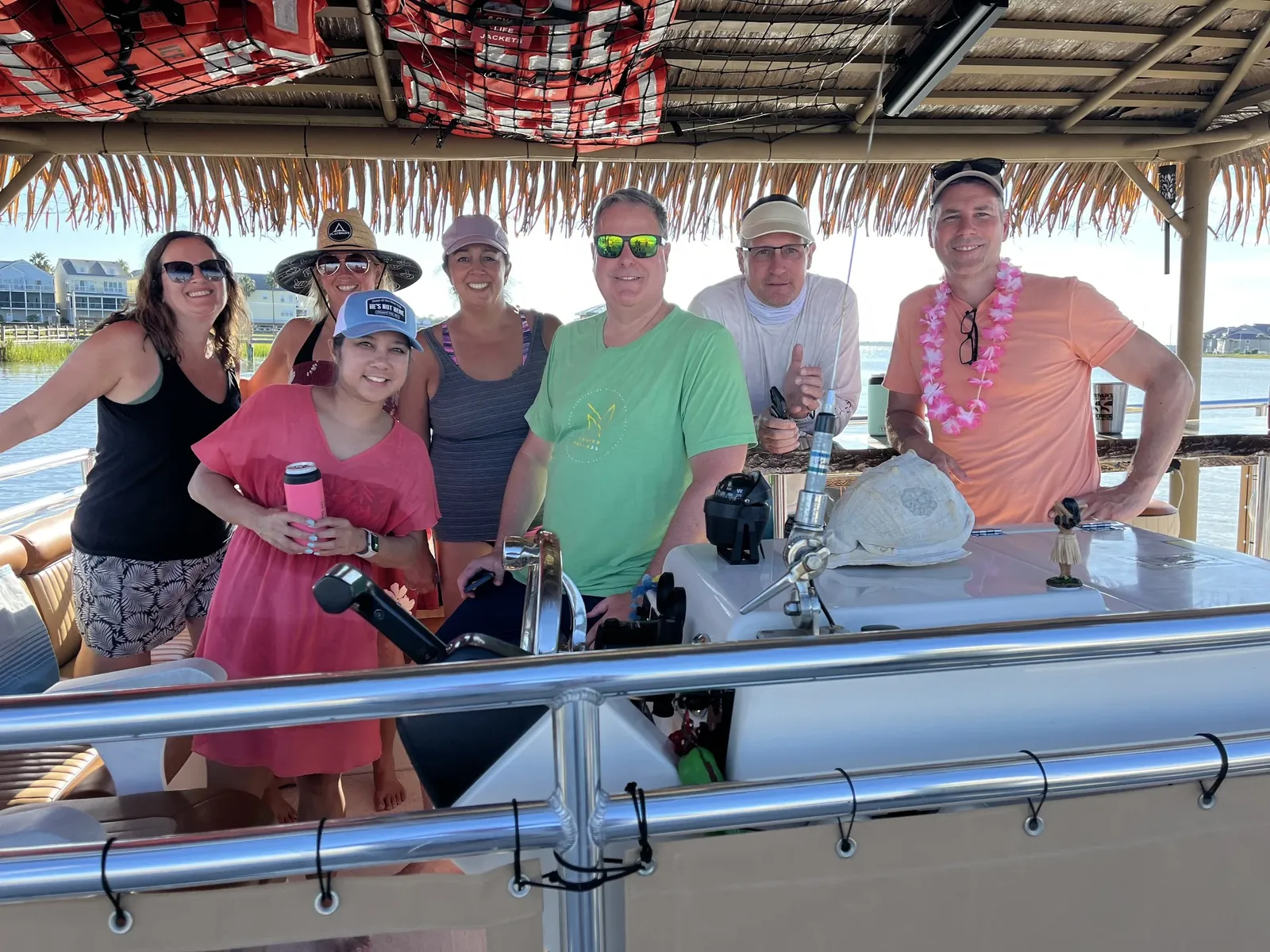Guests around the tiki bar in warm evening light
