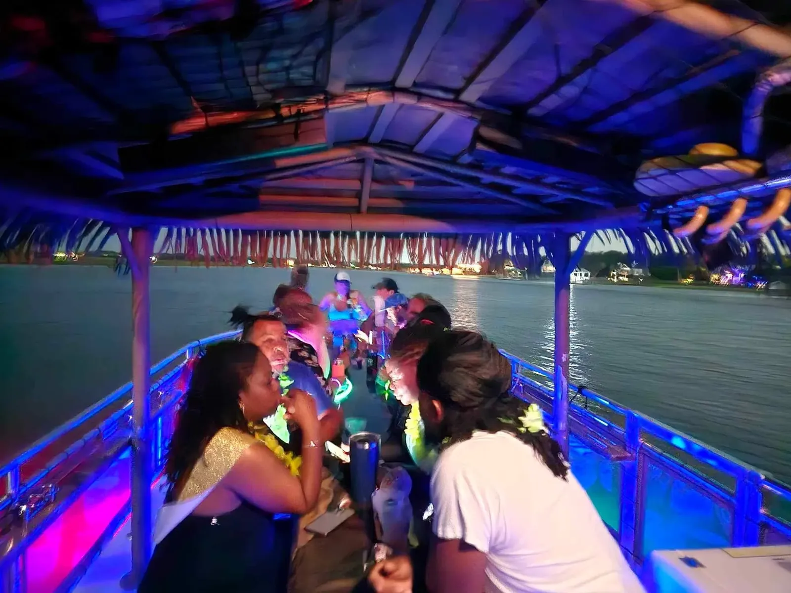 The tiki boat glowing with colored lights during a Saturday night cruise