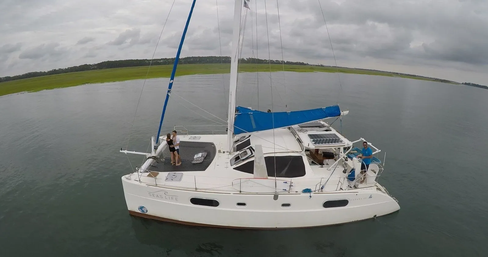 A drone view of the sailing catamaran crossing the salt marsh