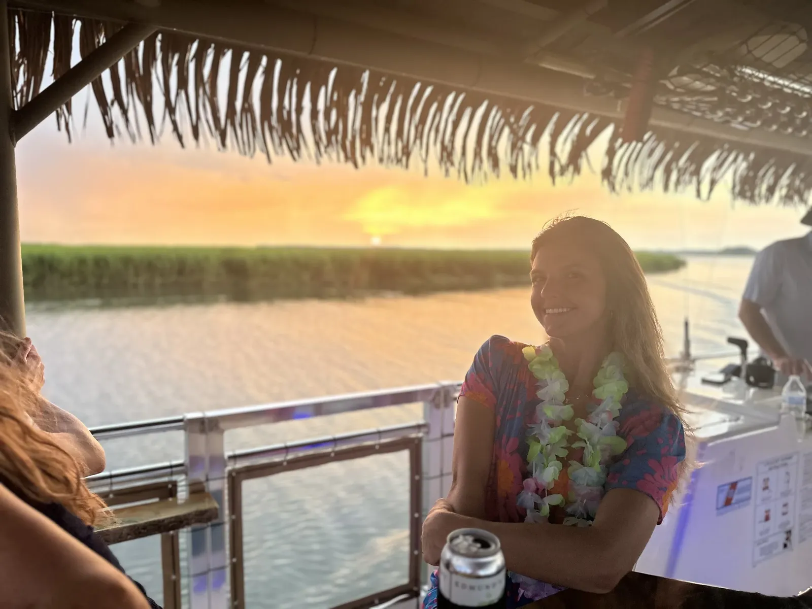 Sunset over the salt marsh seen from the boat's bar rail